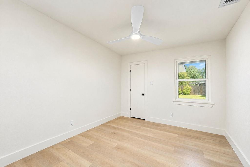 1904 Apollo Road Richardson, TX 75081 - Photo 34 of 40 Bright room with wood-finish flooring, a contemporary ceiling fan with integrated lighting, and a window providing natural illumination