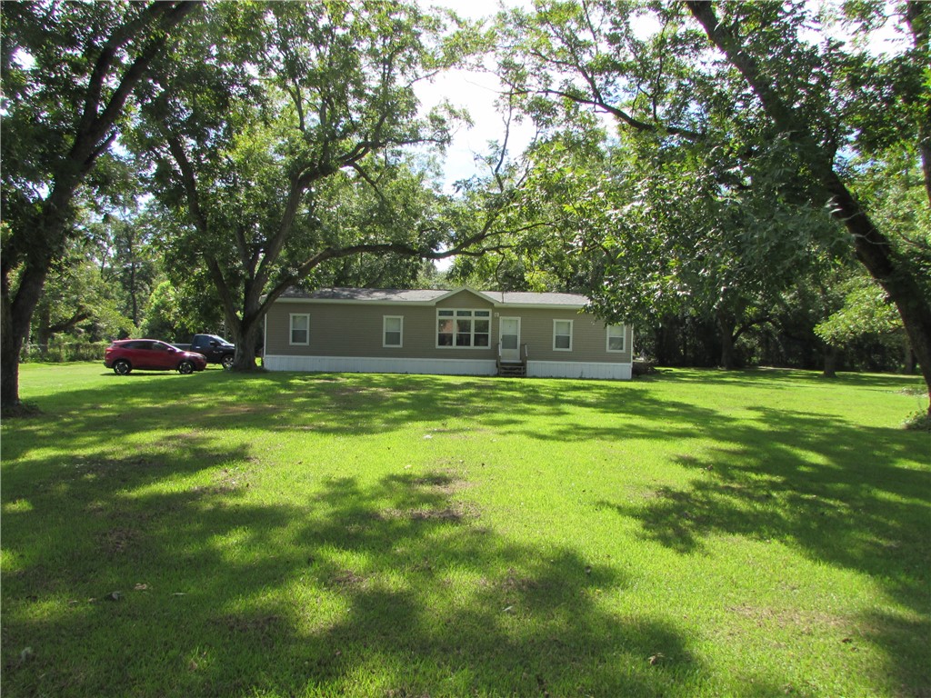 Shaded by income producing pecan trees, you are set well back from the road.  Peaceful area.