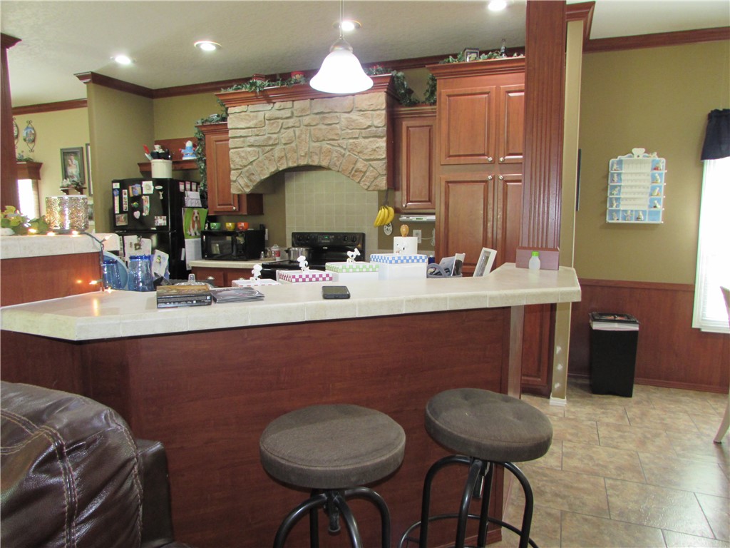 3239 Bob Bowen Road Blackshear, GA 31516 - Photo 15 of 34 On each side of the kitchen island there is space for stools.