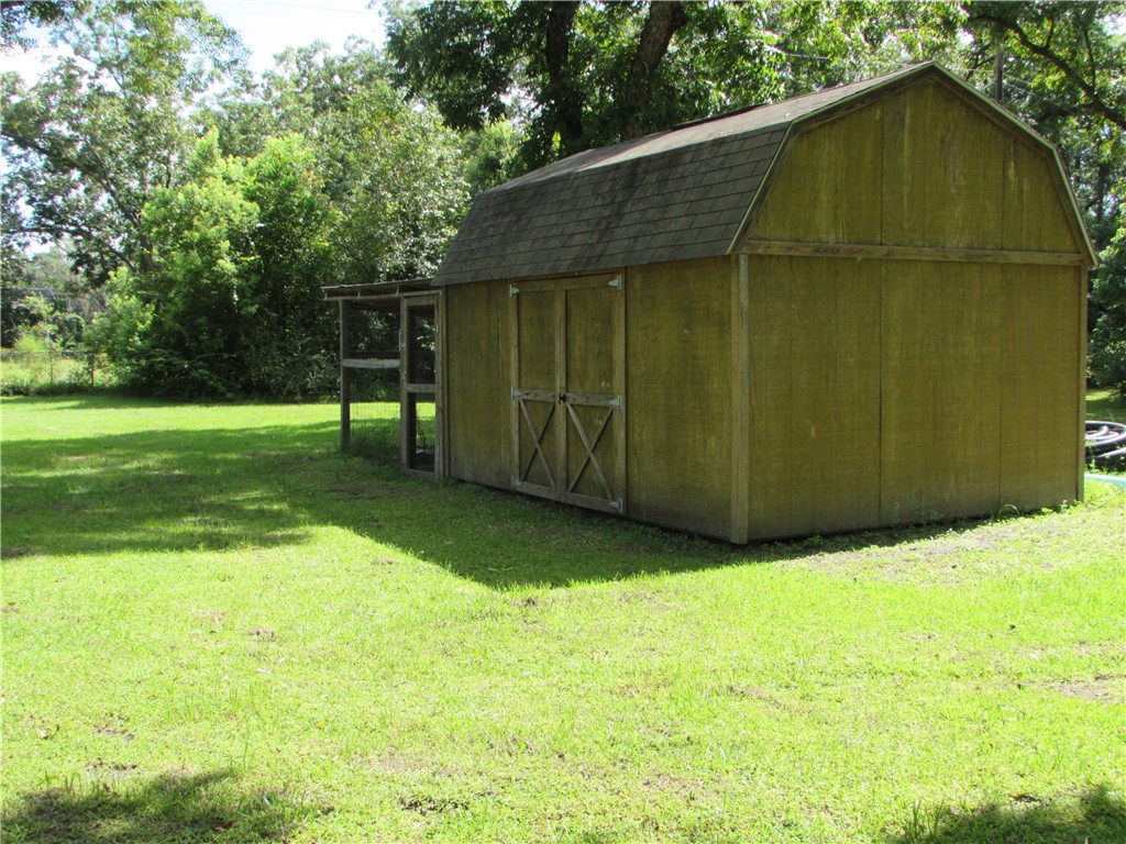3239 Bob Bowen Road Blackshear, GA 31516 - Photo 33 of 34 Out back you'll find a nice workshop/storage with a chicken coop on the end.