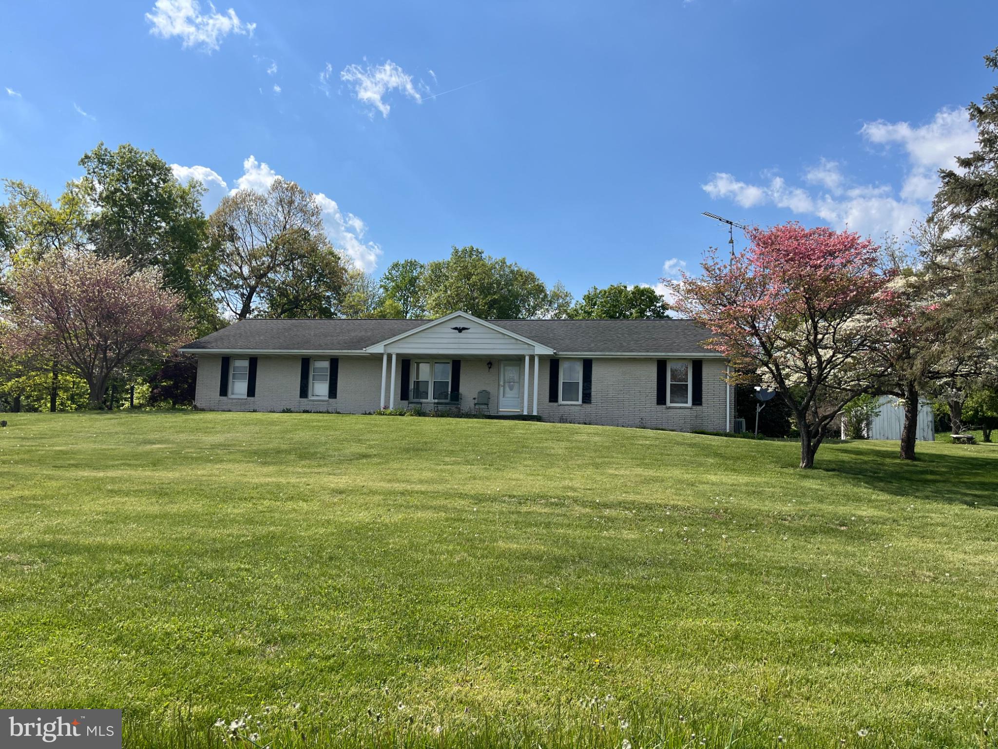 4996 Wentz Road Manchester, MD 21102 - Photo 2 of 8 a front view of a house with a garden