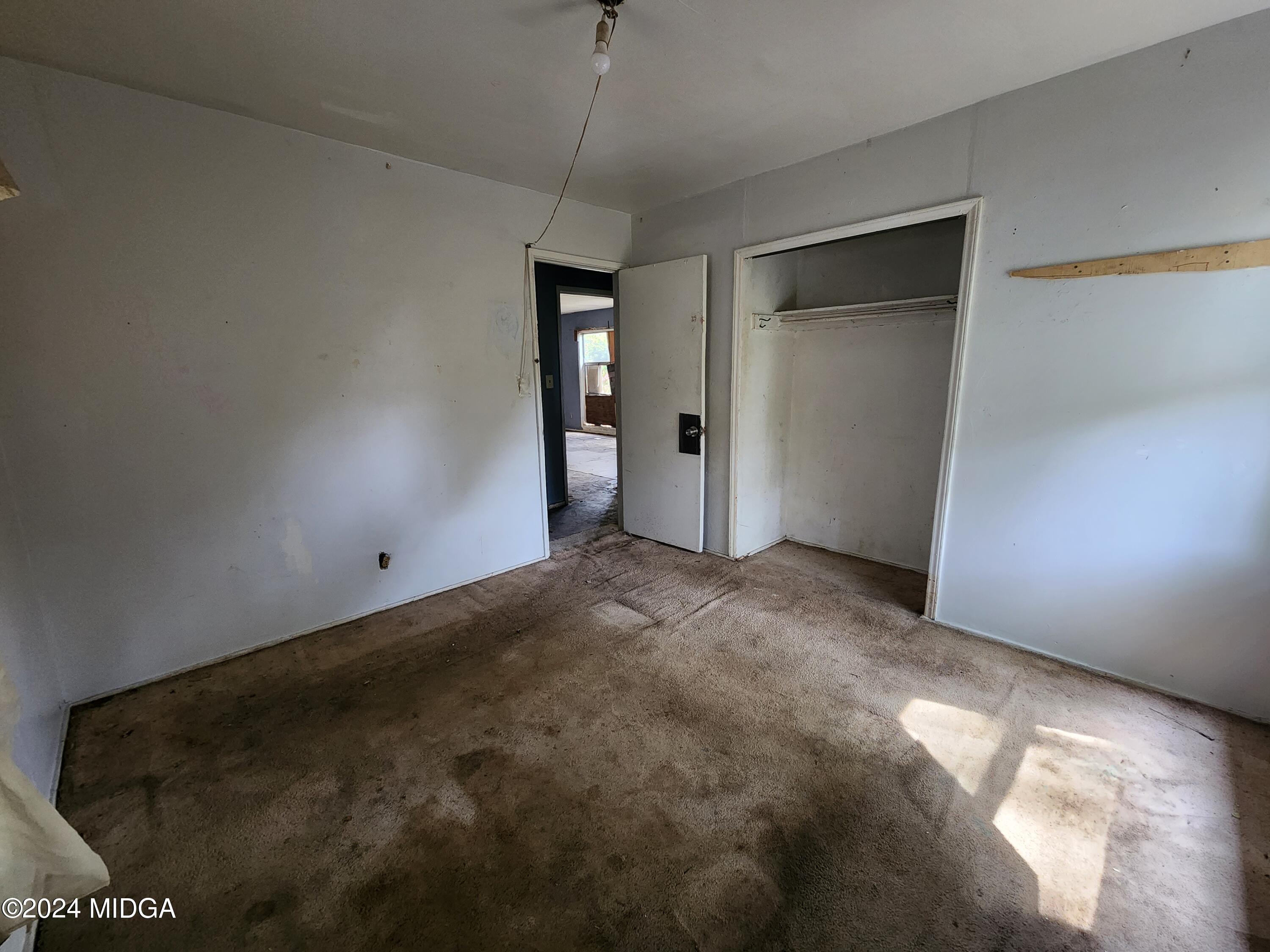 3685 Rice Mill Road Macon, GA 31206 - Photo 20 of 24 a view of an empty room with window and chandelier fan