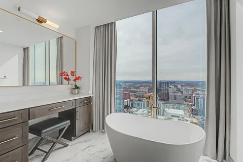 a bedroom with a bed and a large window