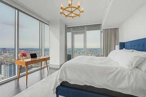 a bed sitting in a bedroom next to a window