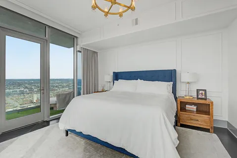 a bedroom with a bed dresser and a window