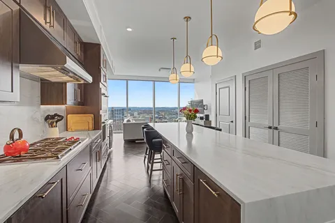 a kitchen with cabinets a stove and a table