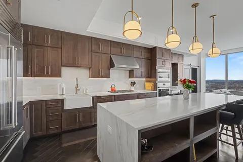 a kitchen with stainless steel appliances a sink dishwasher stove and cabinets