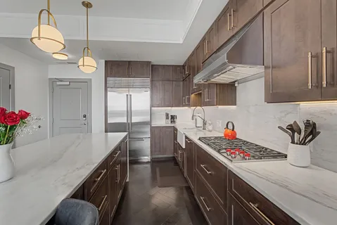 a large kitchen with a table and chairs