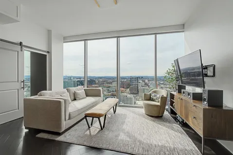 a living room with furniture and flat screen tv