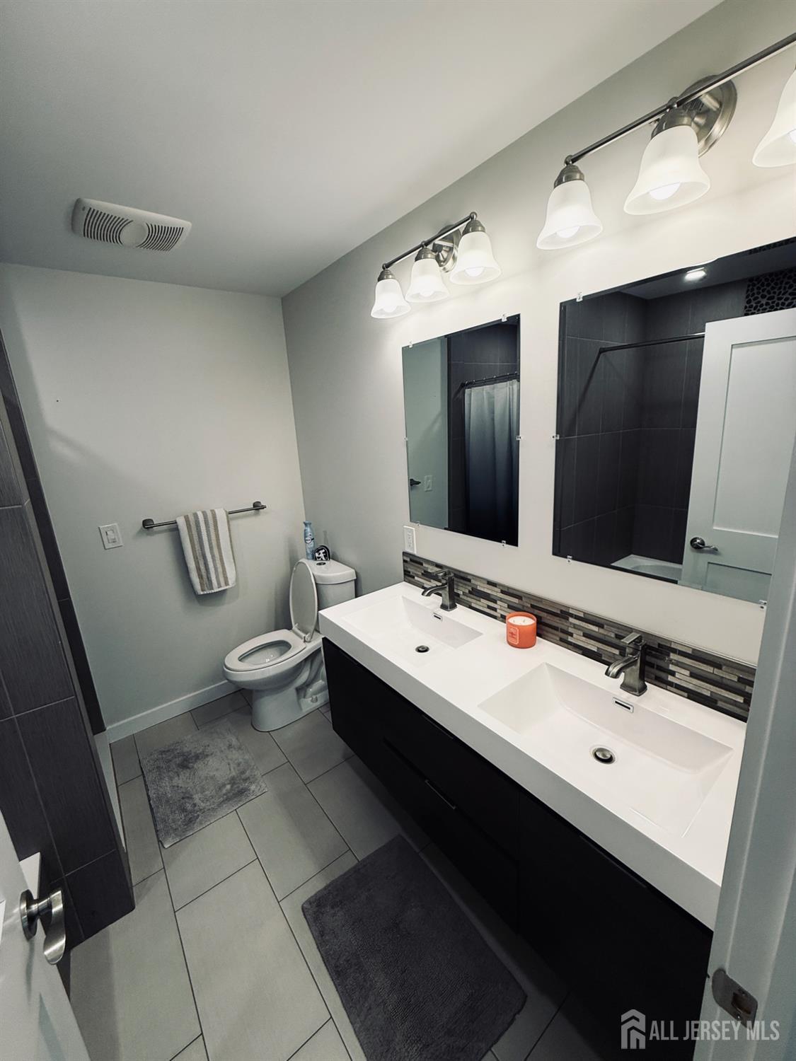 566 Ticetown Road Old Bridge, NJ 08857 - Photo 16 of 23 a bathroom with a double vanity sink and mirror