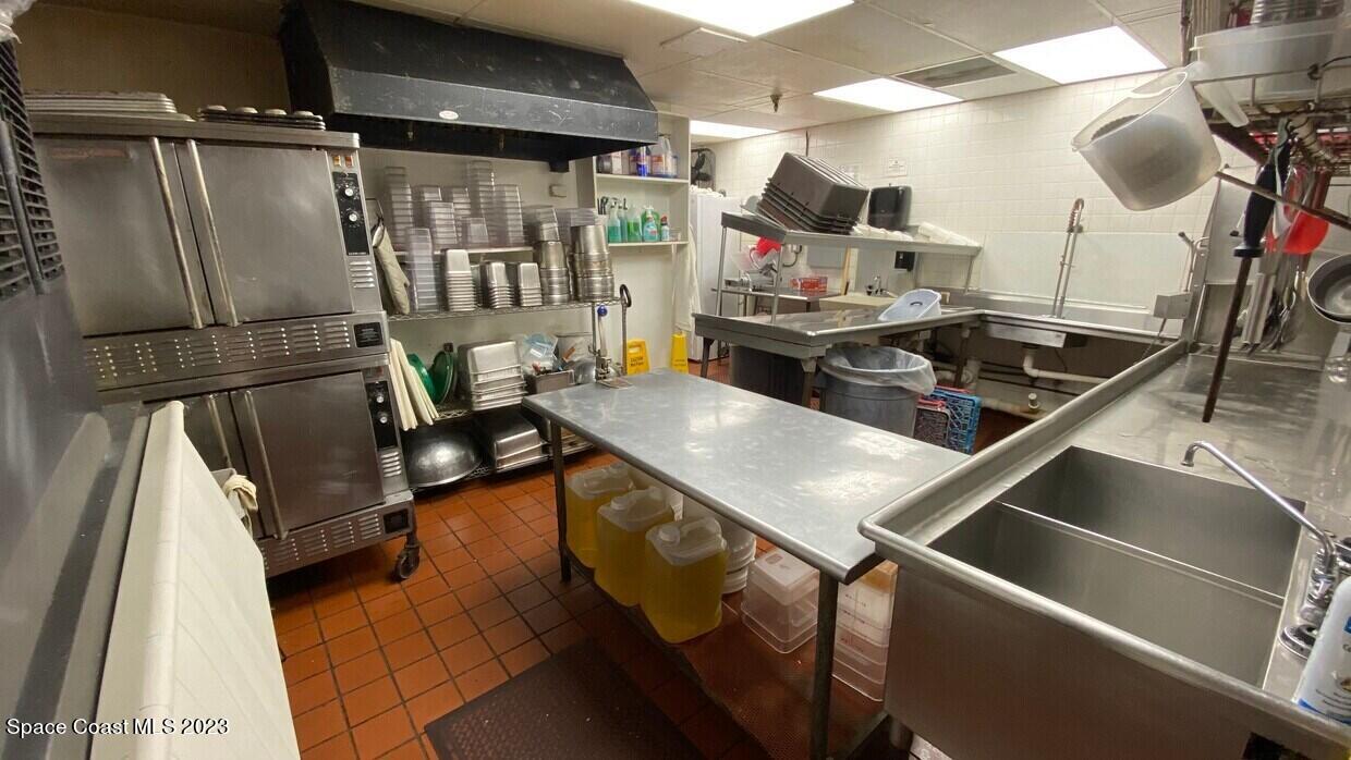 2162 Harris Avenue Northeast Palm Bay, FL 32905 - Photo 10 of 12 a kitchen with a sink stainless steel appliances granite countertop a stove and a refrigerator