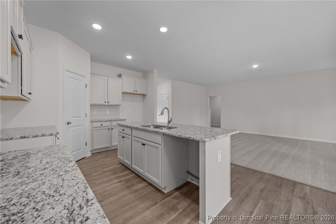 62 Regis Lane Coats, NC 27521 - Photo 11 of 38 a large kitchen with stainless steel appliances granite countertop a sink and cabinets