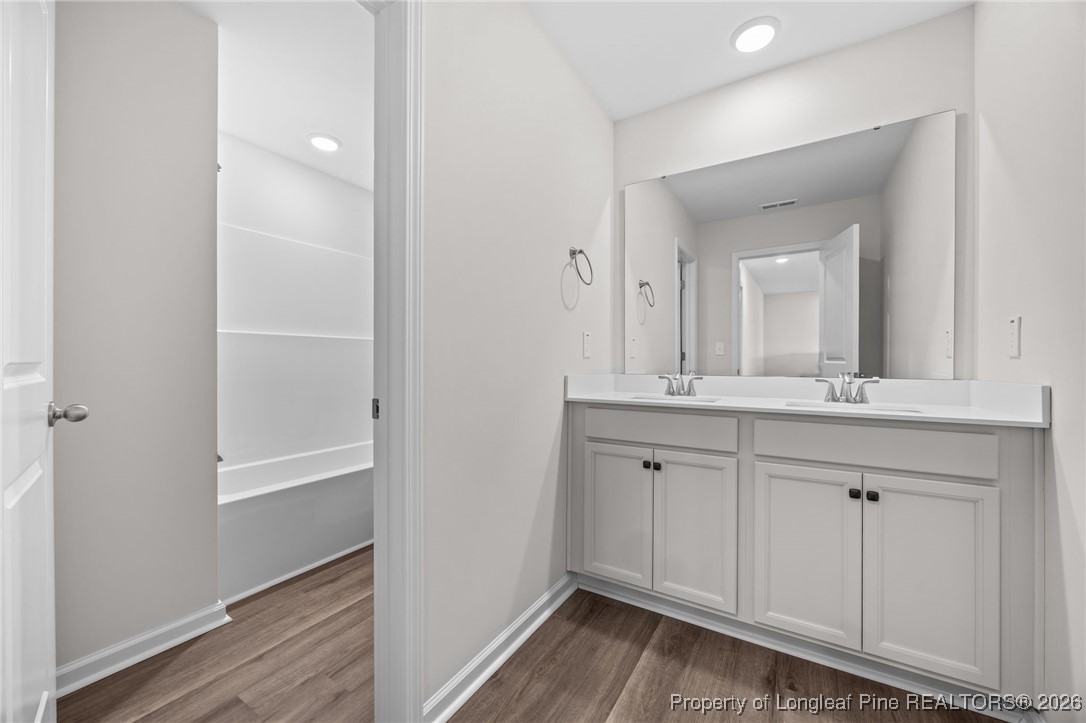 62 Regis Lane Coats, NC 27521 - Photo 24 of 38 a bathroom with a sink and a mirror