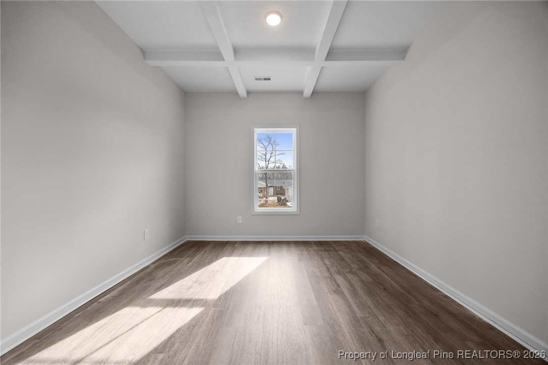 62 Regis Lane Coats, NC 27521 - Photo 3 of 38 a view of empty room with wooden floor and fan