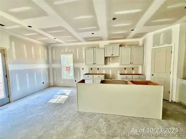 a living room with stainless steel appliances kitchen island granite countertop a stove and a refrigerator