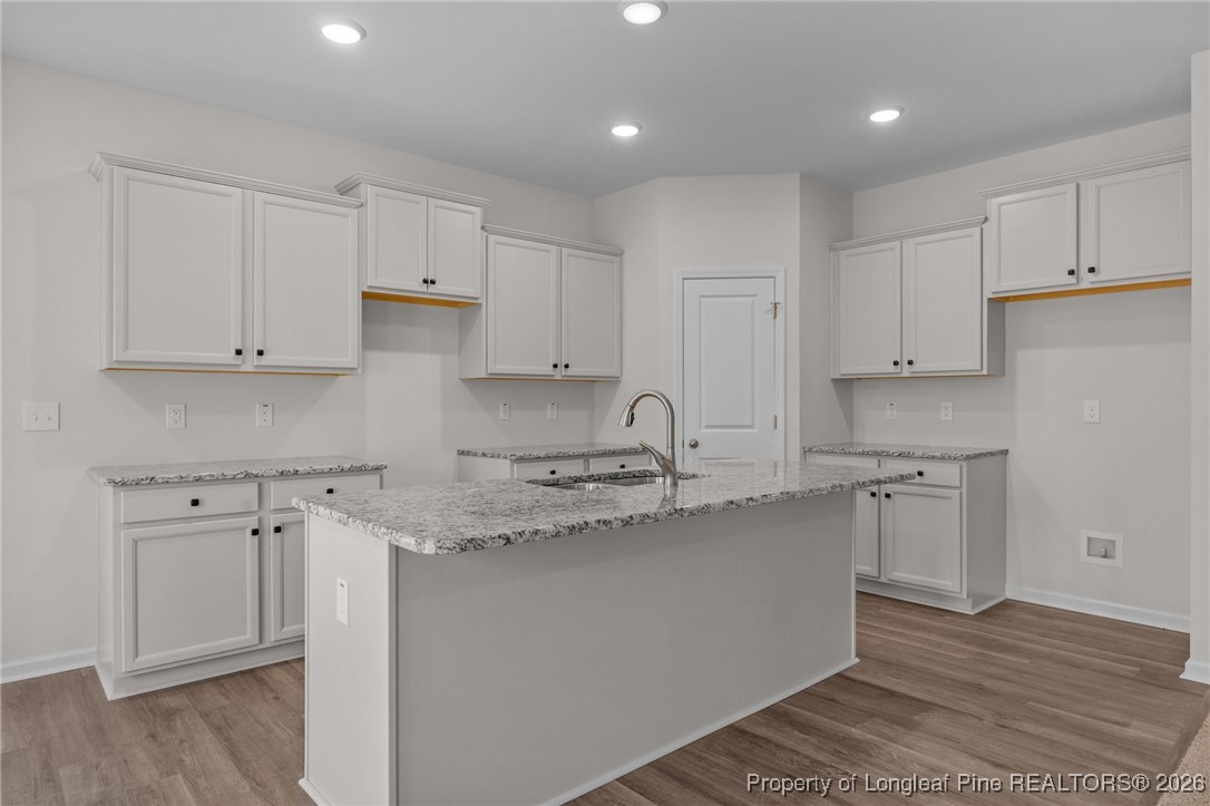 62 Regis Lane Coats, NC 27521 - Photo 10 of 38 a kitchen with stainless steel appliances granite countertop a sink a stove a refrigerator and white cabinets