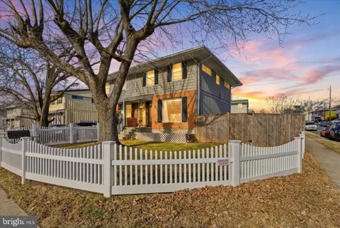 a view of a house with a wooden fence