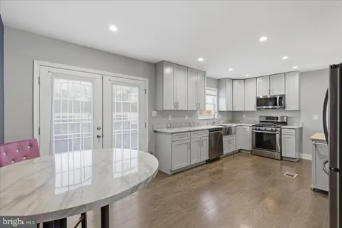 a kitchen with granite countertop stainless steel appliances and cabinets
