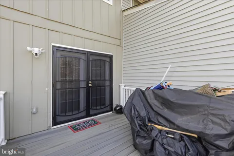 a view of a balcony with wooden floor and fence