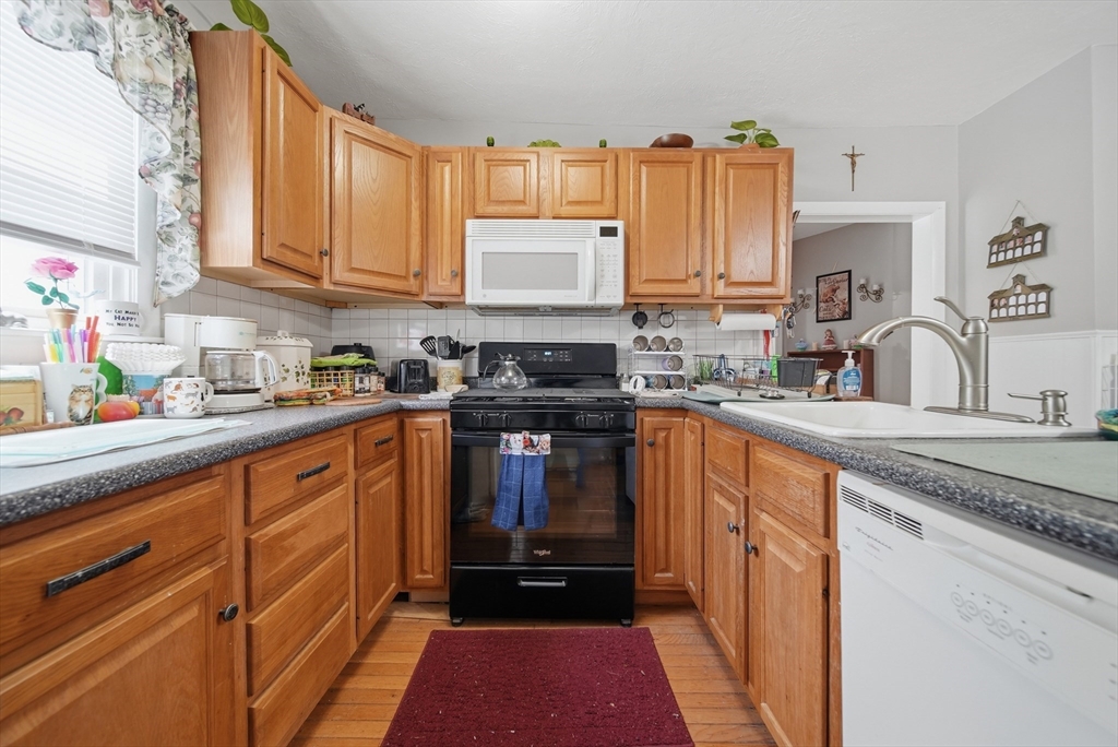436 Franklin Road Fitchburg, MA 01420 - Photo 8 of 41 a kitchen with granite countertop a sink stove and cabinets