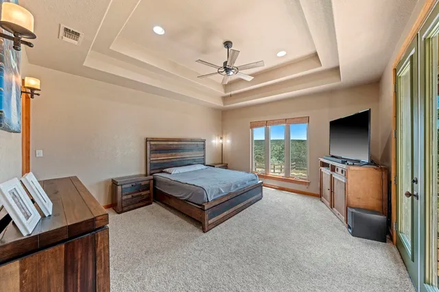 a bedroom with furniture and a flat screen tv