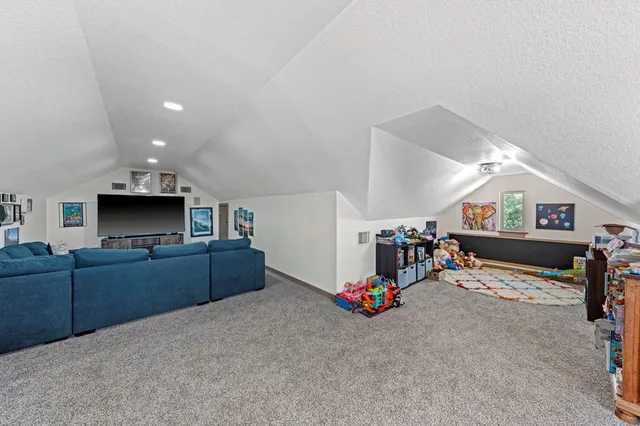 a bedroom with furniture and a flat screen tv