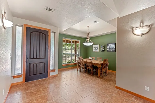 a view of a dining room with furniture window and outside view
