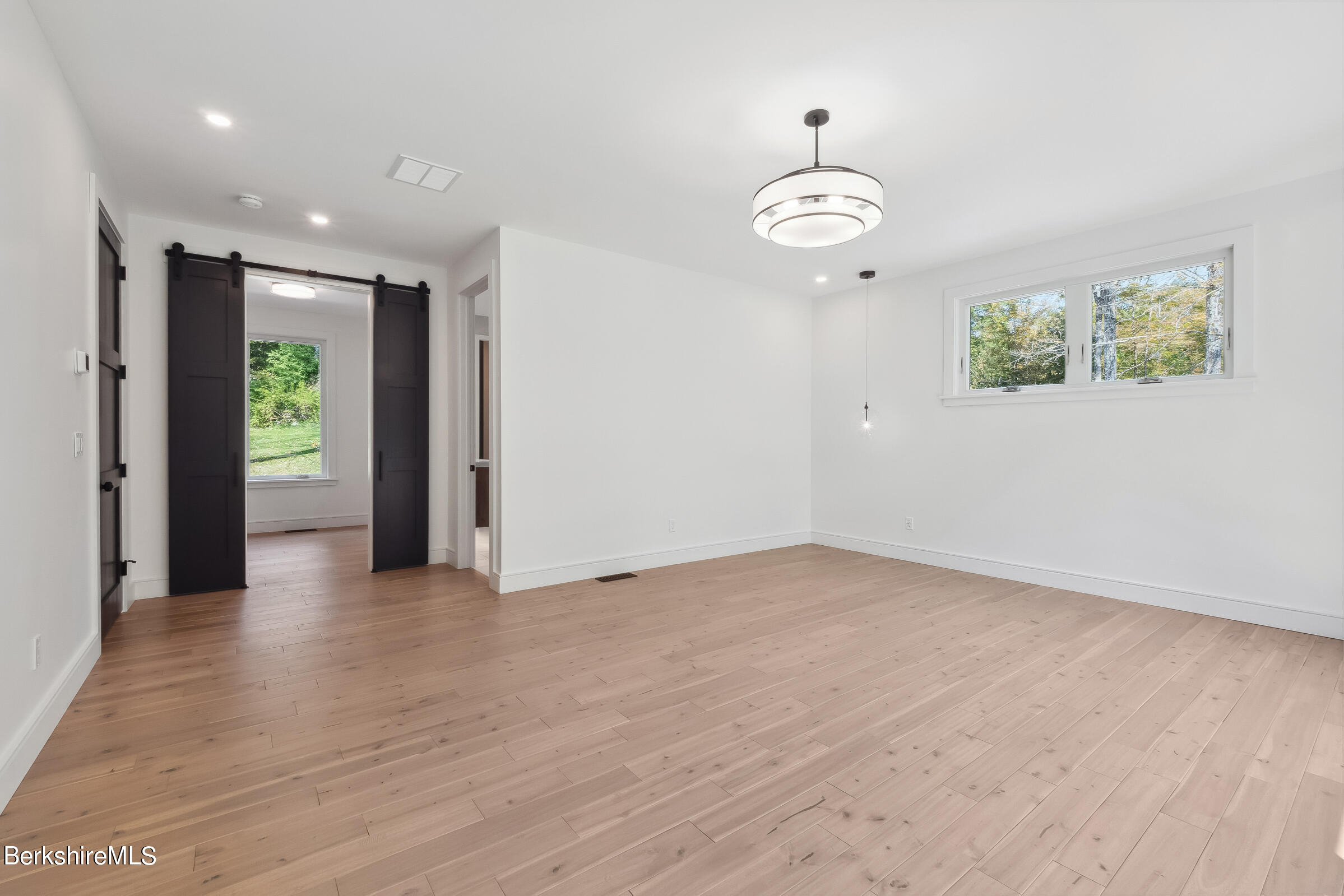112 Tyringham Road Monterey, MA 01245 - Photo 24 of 57 an empty room with wooden floor ceiling fan and window