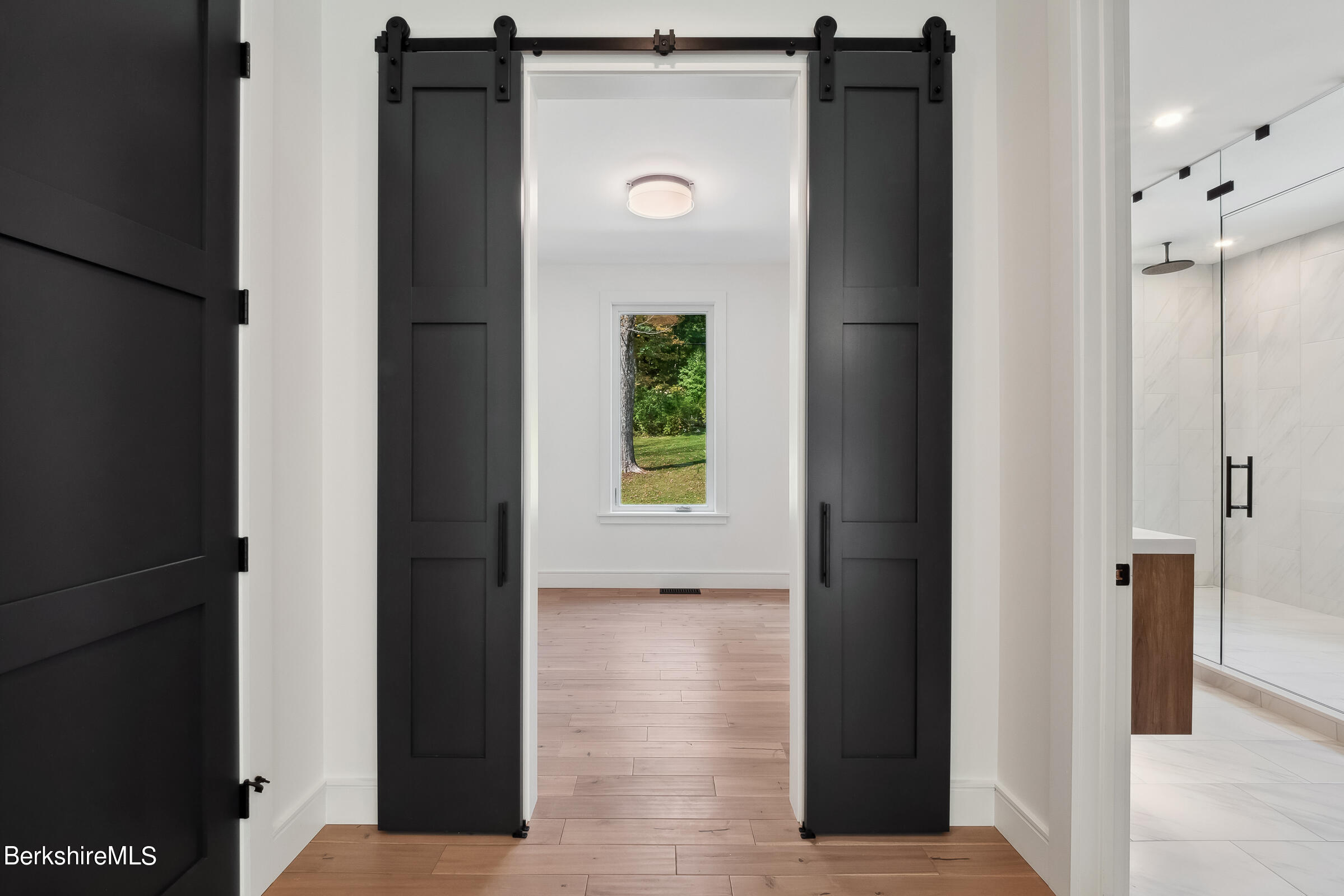 112 Tyringham Road Monterey, MA 01245 - Photo 25 of 57 a view of a hallway with wooden floor and a bathroom
