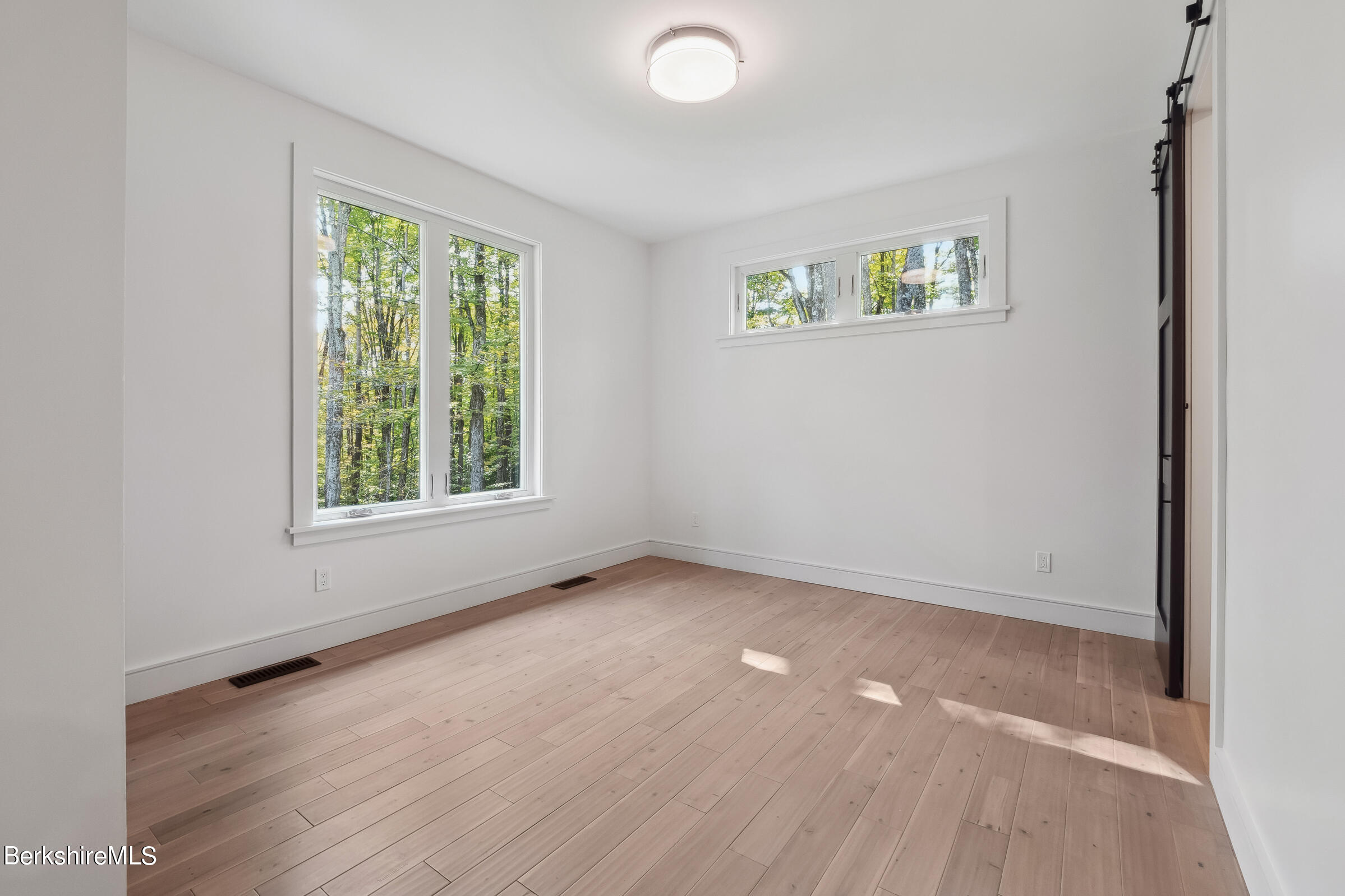 112 Tyringham Road Monterey, MA 01245 - Photo 38 of 57 an empty room with windows