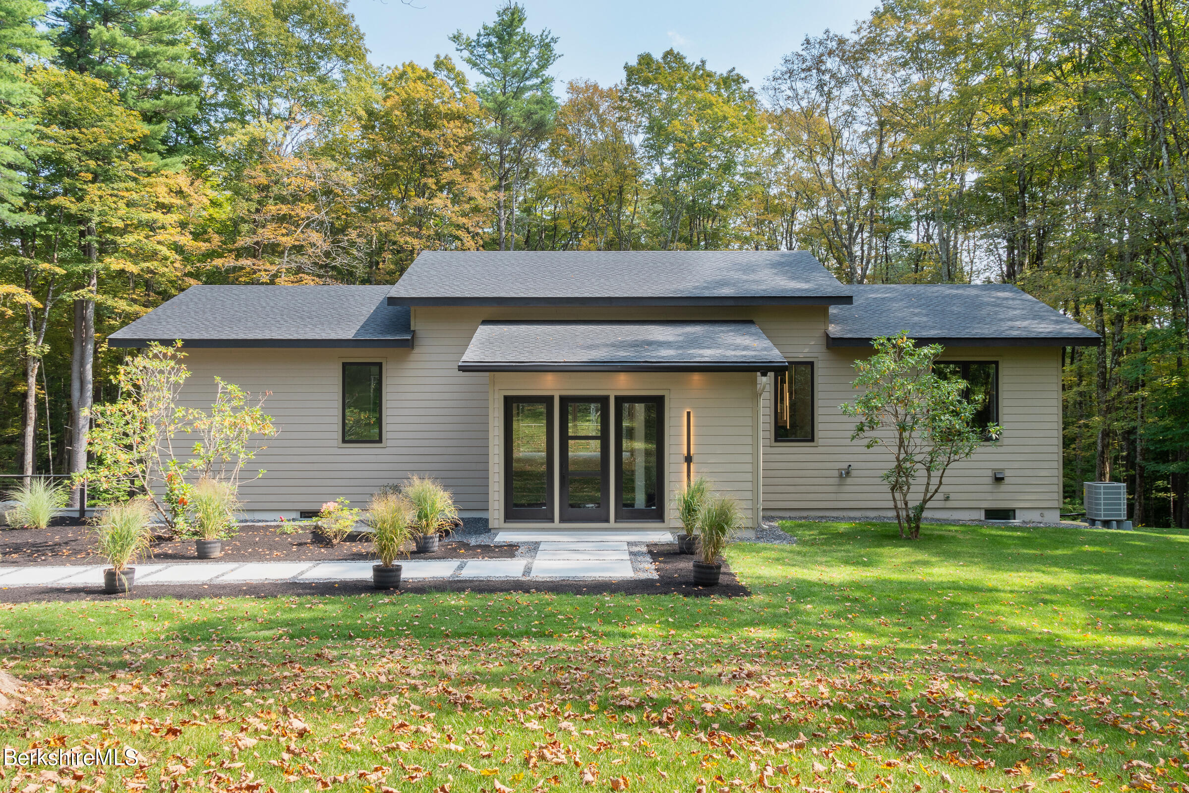 112 Tyringham Road Monterey, MA 01245 - Photo 54 of 57 a view of a house with a yard porch and sitting area