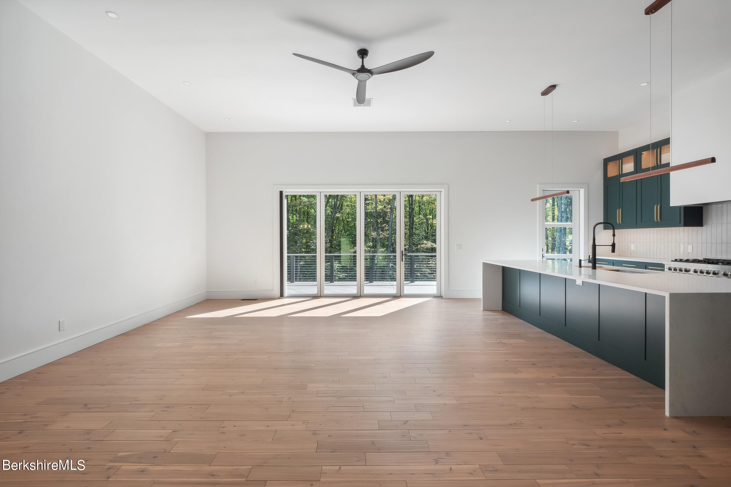 112 Tyringham Road Monterey, MA 01245 - Photo 7 of 57 a view of an empty room with a window and a kitchen