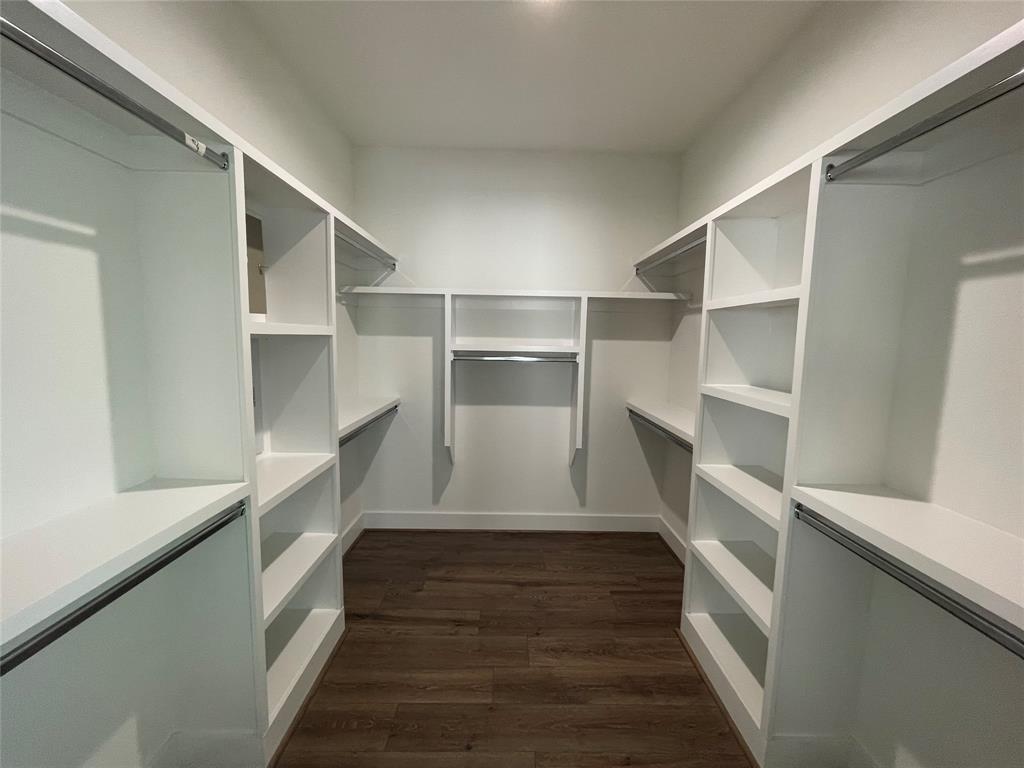 3535 Spring Avenue Dallas, TX 75210 - Photo 10 of 19 Walk in closet featuring dark wood finished floors