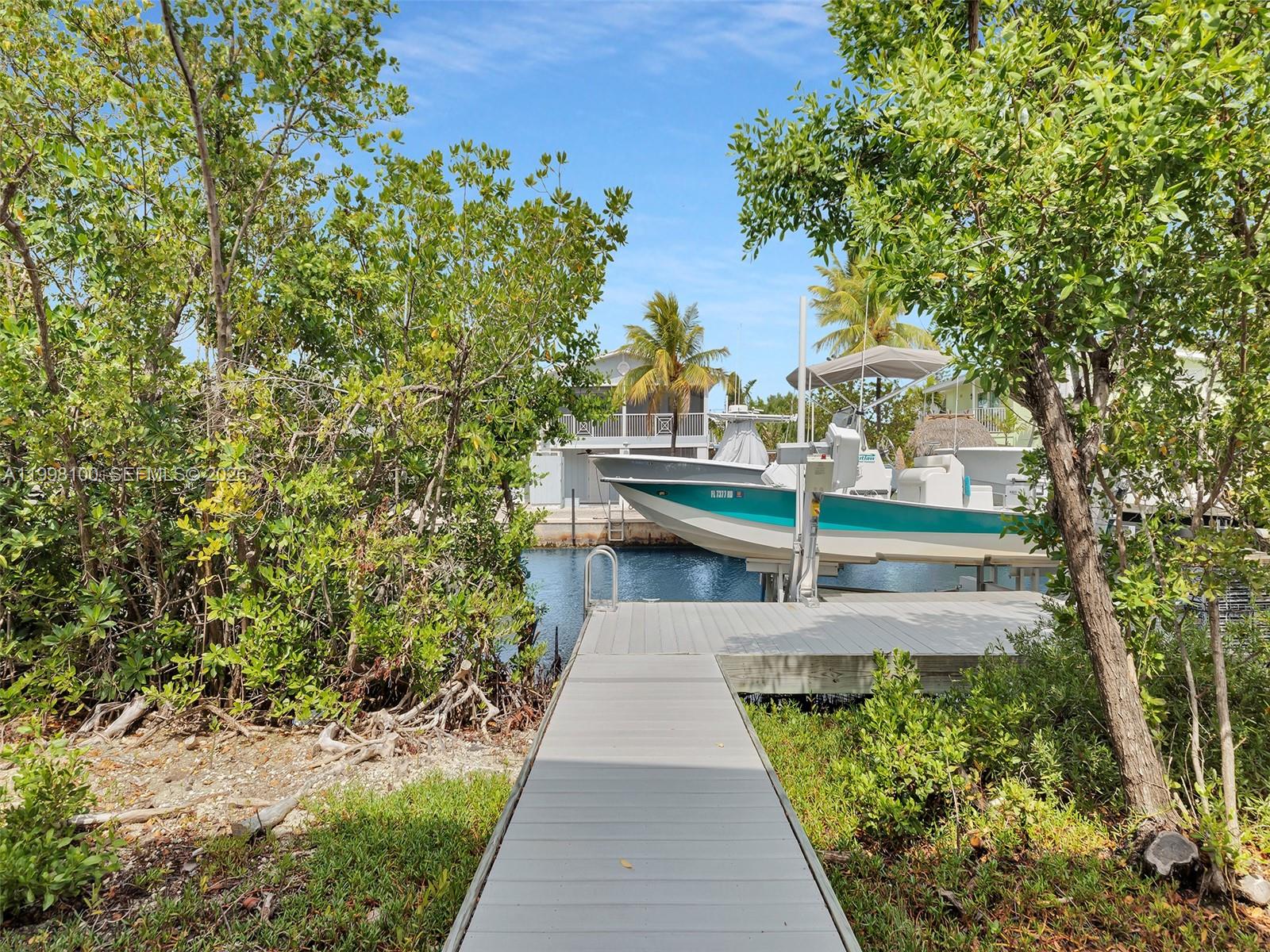 437 Pirates Road Summerland Key, FL 33042 - Photo 11 of 39 a view of balcony with wooden floor and fence