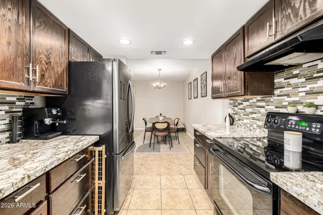 a kitchen with stainless steel appliances granite countertop a stove and a sink