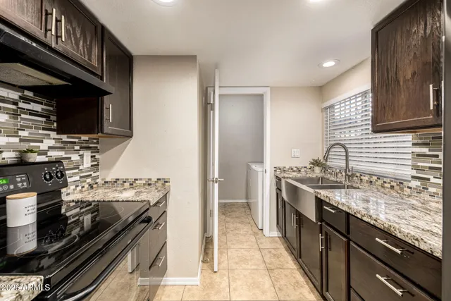 a kitchen with a sink and a refrigerator