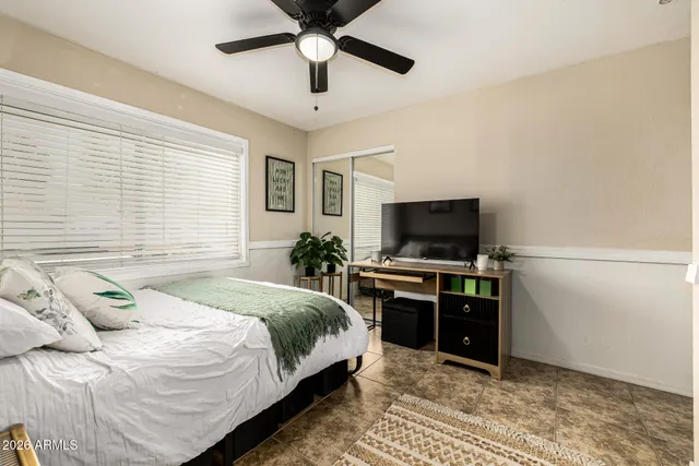 a bedroom with a large bed and a chandelier
