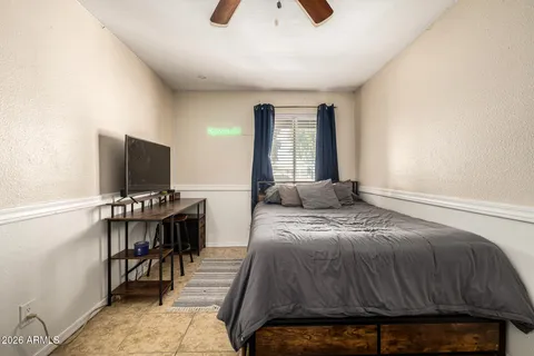 a bedroom with a bed and a chandelier