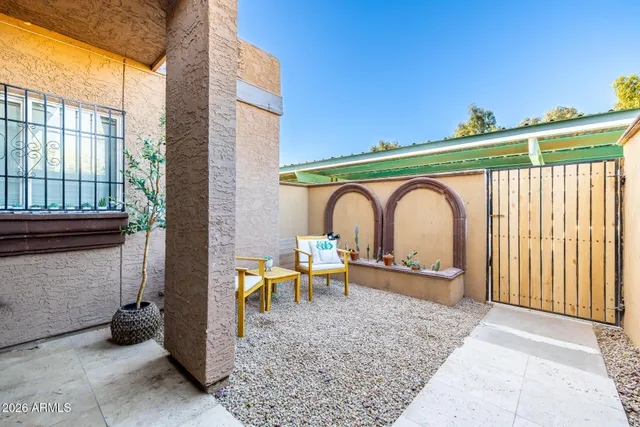 a backyard of a house with table and chairs