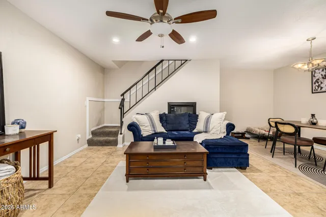 a living room with furniture and a chandelier