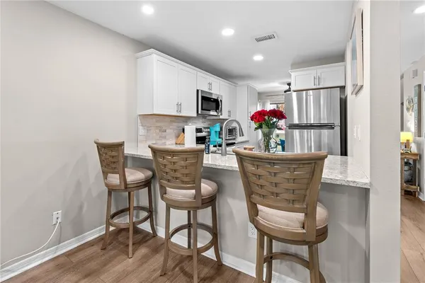 a view of a dining room with furniture wooden floor and kitchen view