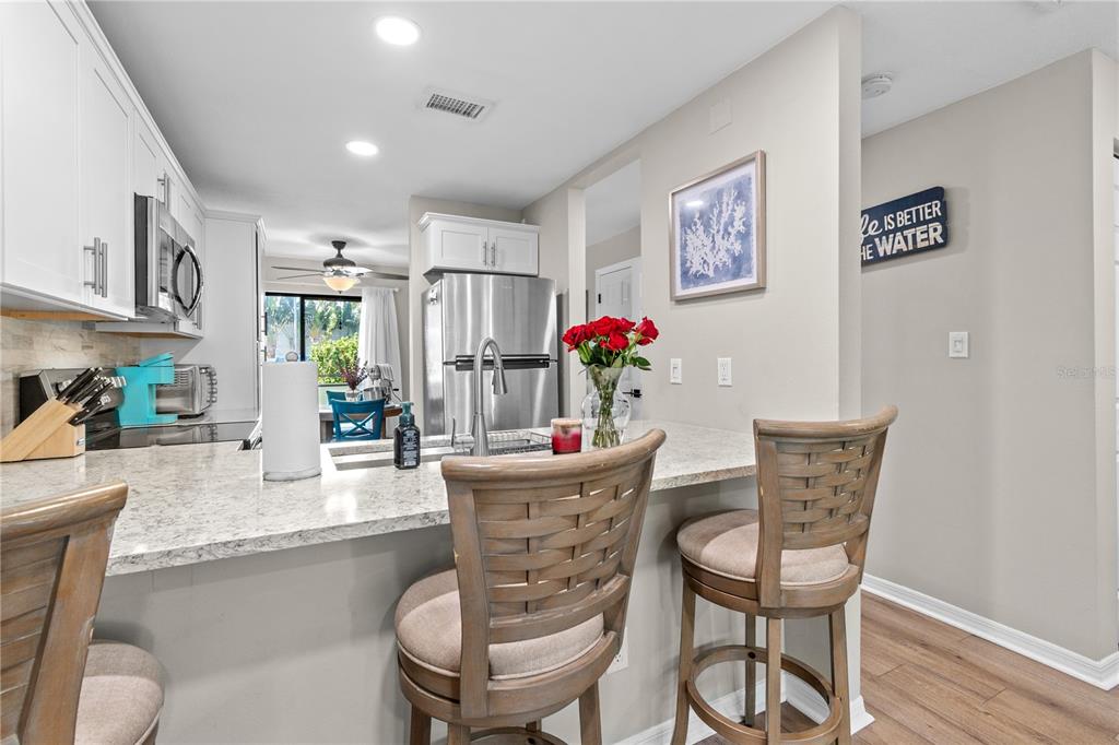 1752 Stickney Point Road, Unit 102 Sarasota, FL 34231 - Photo 13 of 50 a dining room with furniture and window