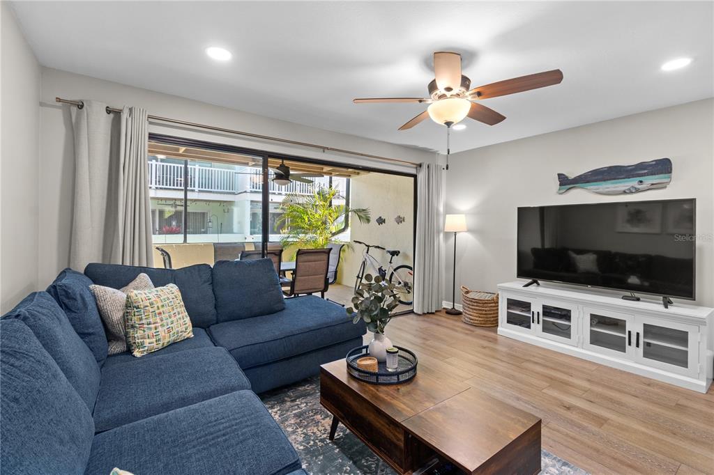 1752 Stickney Point Road, Unit 102 Sarasota, FL 34231 - Photo 18 of 50 a living room with furniture and a flat screen tv