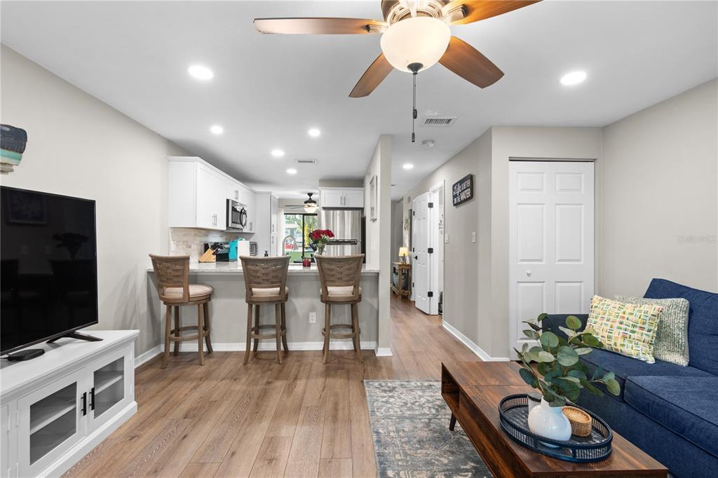 1752 Stickney Point Road, Unit 102 Sarasota, FL 34231 - Photo 23 of 50 a living room with furniture and a flat screen tv