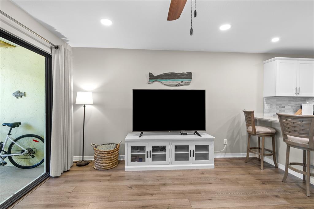 1752 Stickney Point Road, Unit 102 Sarasota, FL 34231 - Photo 24 of 50 a bedroom with furniture and a flat screen tv