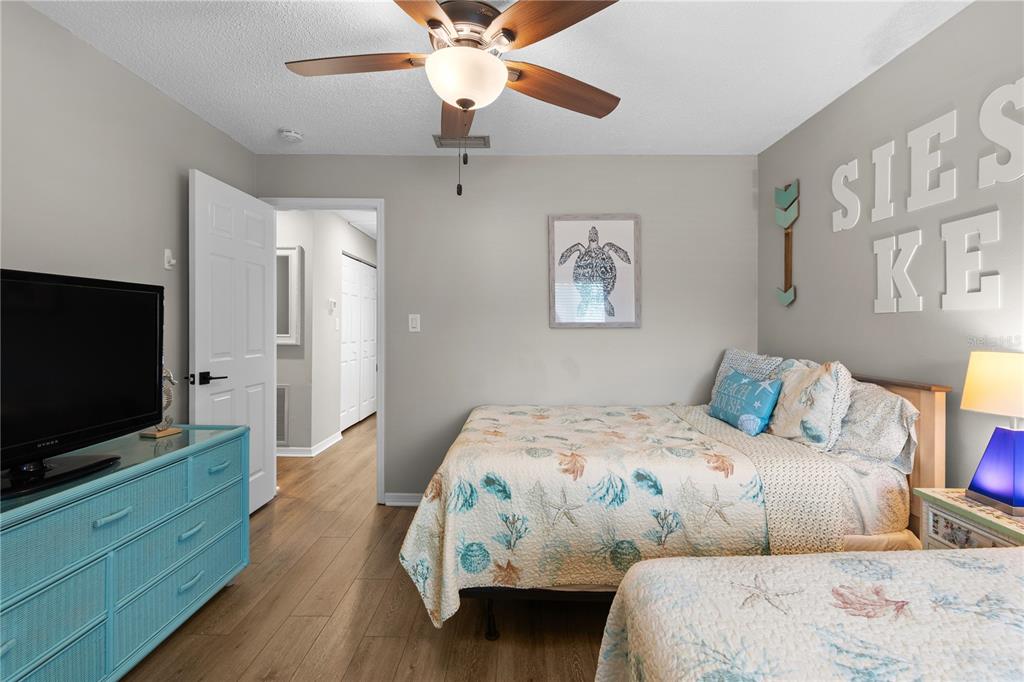 1752 Stickney Point Road, Unit 102 Sarasota, FL 34231 - Photo 31 of 50 a bedroom with a bed and a flat screen tv