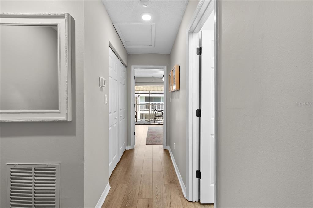 1752 Stickney Point Road, Unit 102 Sarasota, FL 34231 - Photo 32 of 50 a view of a hallway with wooden floor and entryway