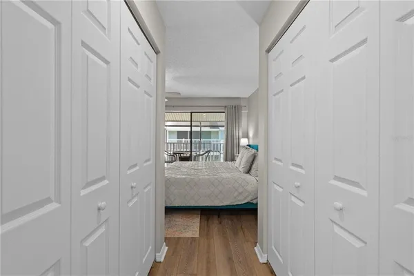 a large bedroom with a bed and a large window