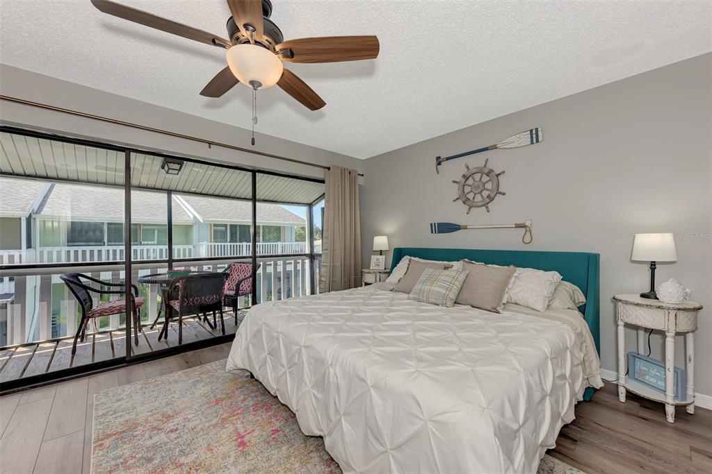 1752 Stickney Point Road, Unit 102 Sarasota, FL 34231 - Photo 37 of 50 a large bedroom with a bed and a large window