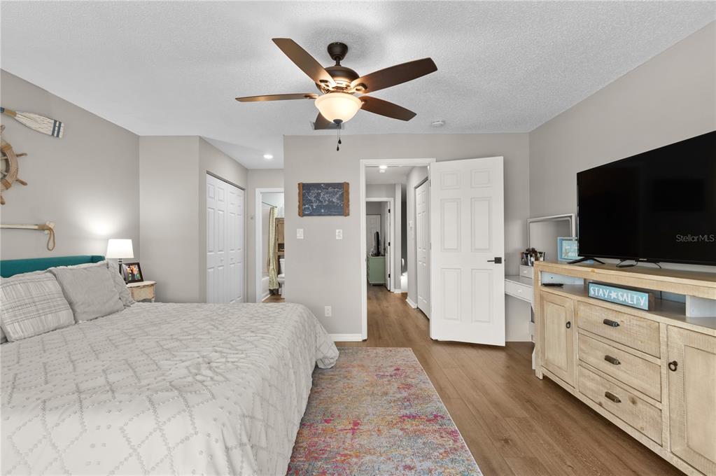 1752 Stickney Point Road, Unit 102 Sarasota, FL 34231 - Photo 41 of 50 a bedroom with a bed and a flat screen tv